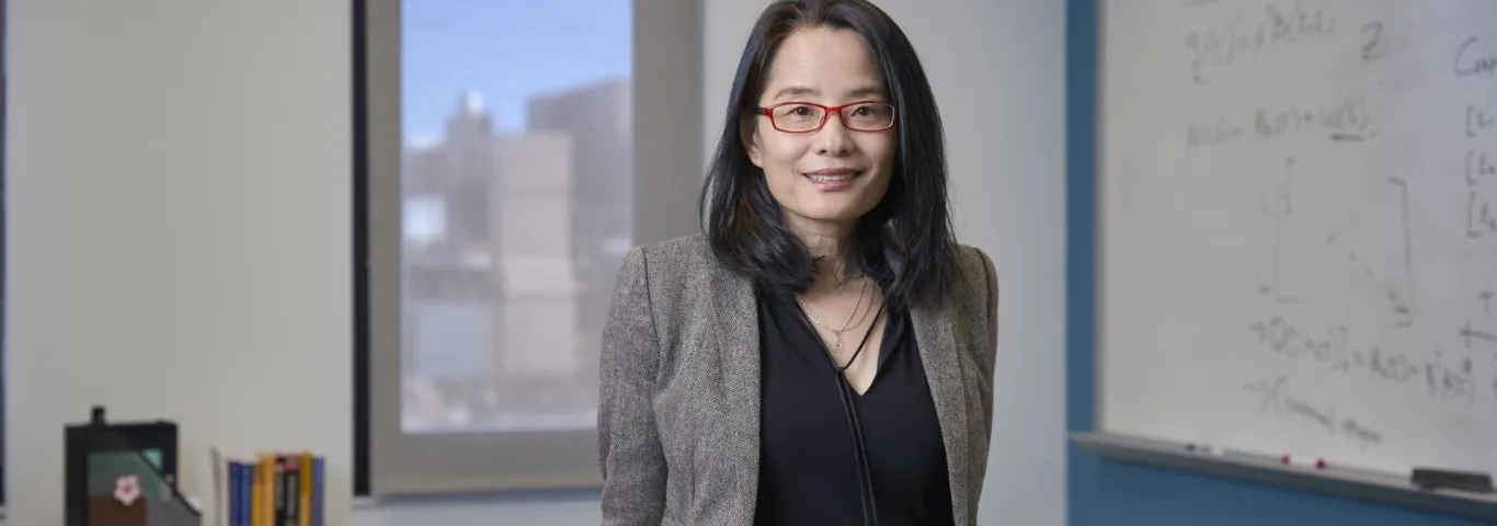 Bo Li sits on her desk