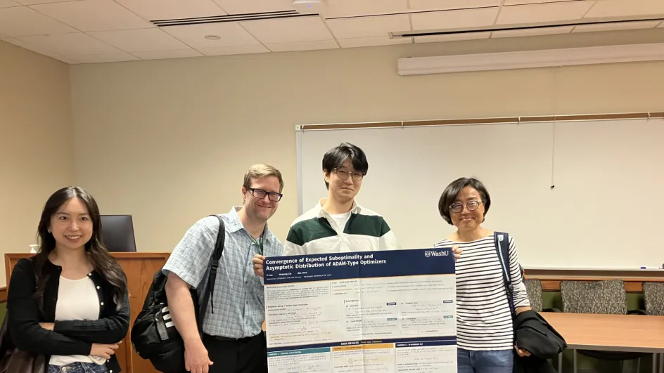 Poster winner Yi Luo poses with his project and the competitions judges.