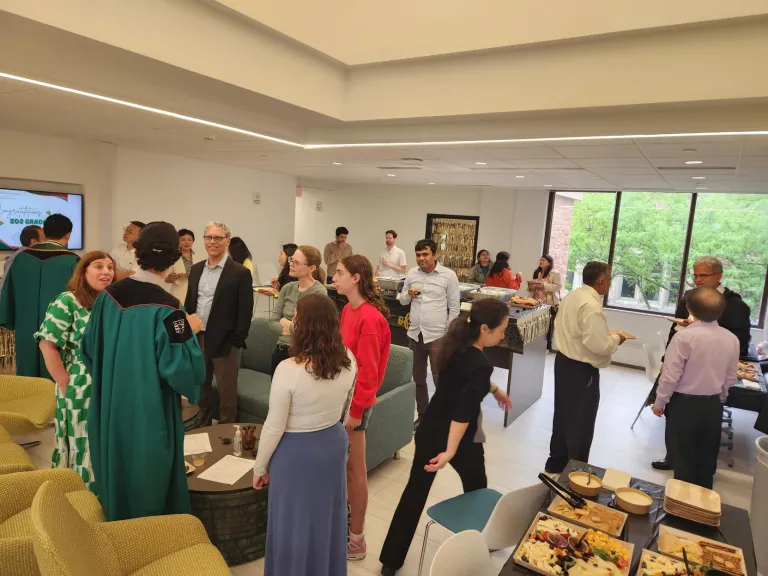 Students, their families, and professors eat and chat in the Jolley Hall fifth floor lobby