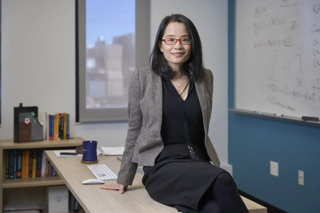 Bo Li sits on her desk